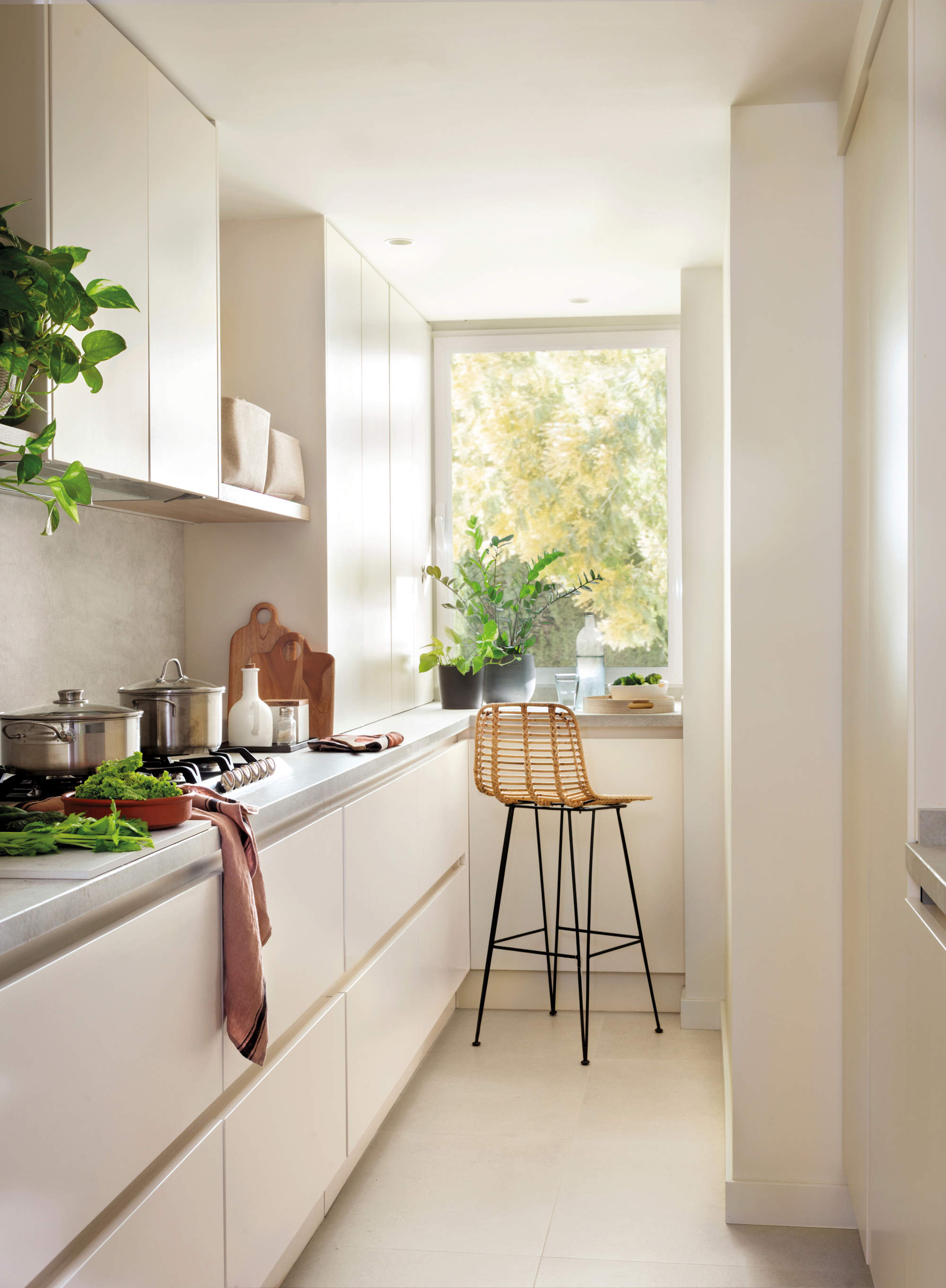 Cocina pequeña con barra de desayunos bajo la ventana